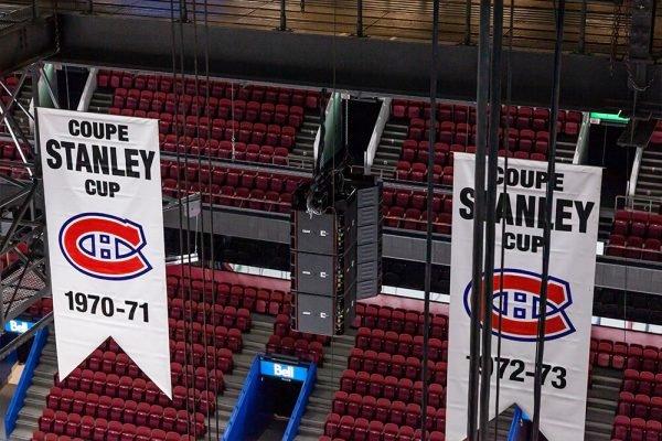 a large banner hanging from the ceiling of a hockey arena